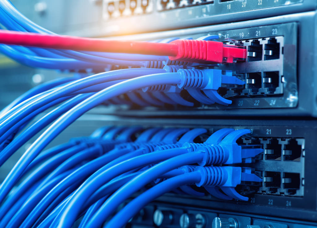 network cables and hub closeup with fiber optical background